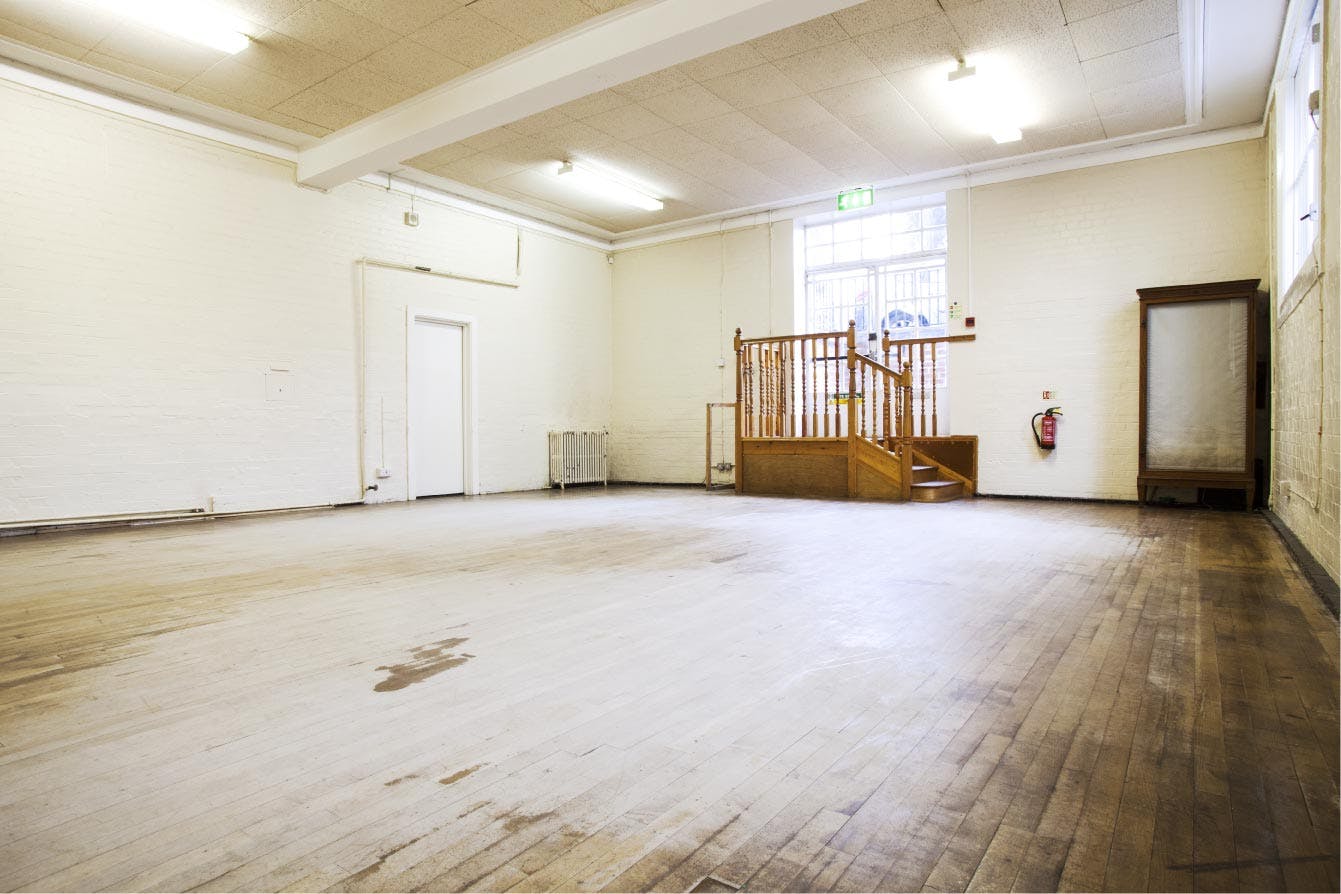 Spacious Storrow Room at Cecil Sharp House, ideal for versatile events with wooden flooring.